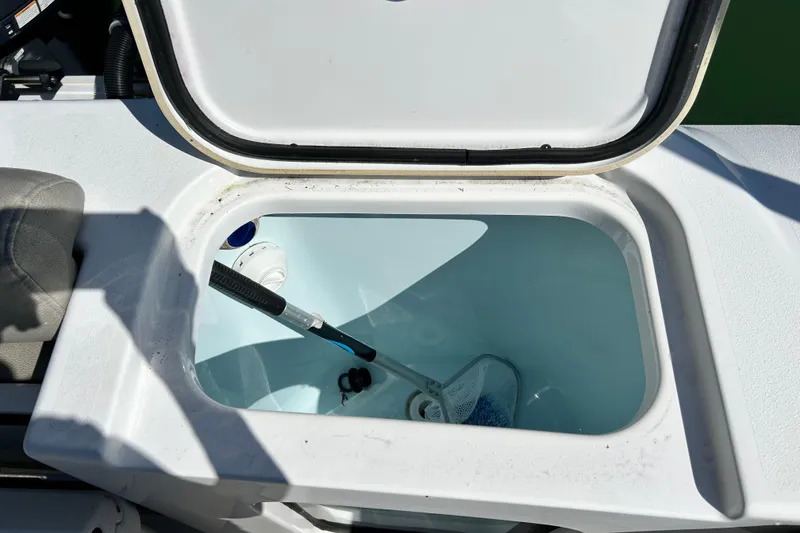 Slide: The Image of Open livewell on 2021 Sportsman Open 302 Center Console boat, showing interior and equipment. - 19