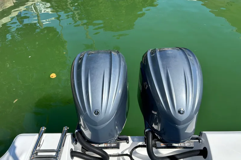 Slide: The Image of Twin outboard engines on a 2021 Sportsman Open 302 Center Console boat. - 21