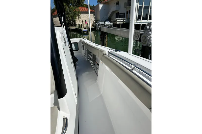 Slide: The Image of 2021 Sportsman Open 302 Center Console boat docked at marina. - 22