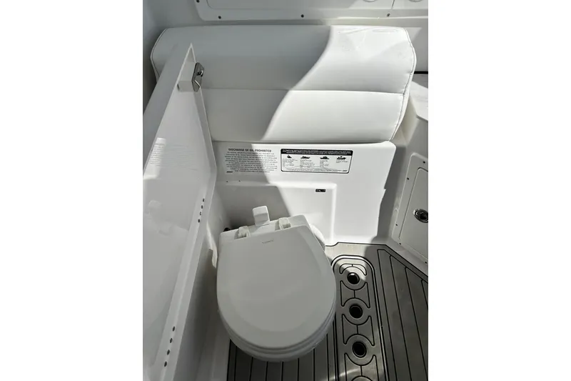 Slide: The Image of 2021 Sportsman Open 302 Center Console boat interior with marine toilet. - 23