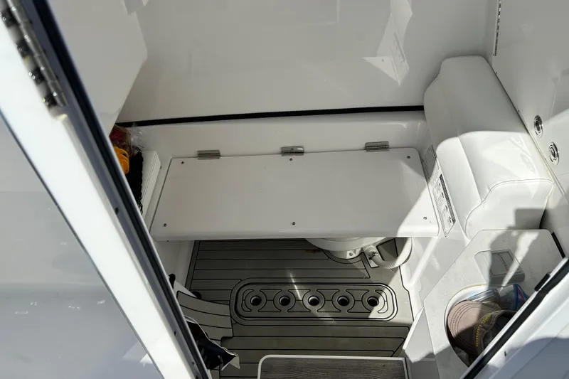 Slide: The Image of 2021 Sportsman Open 302 Center Console interior with seating and storage area. - 24