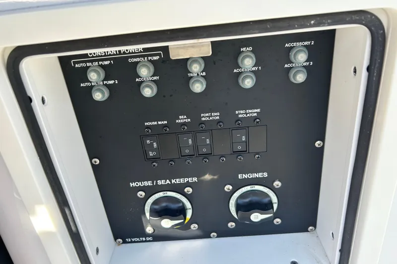 Slide: The Image of Control panel of a 2021 Sportsman Open 302 Center Console boat, featuring various switches. - 27