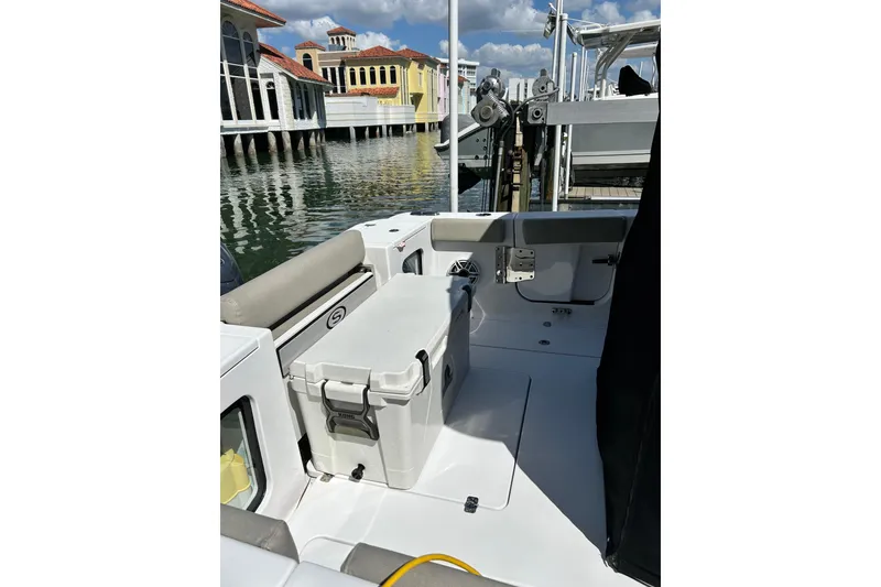 Slide: The Image of 2021 Sportsman Open 302 Center Console boat interior with cooler and seating. - 3