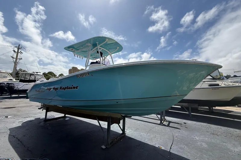 The Image of 2019 NauticStar 2602 Legacy boat on display under a partly cloudy sky. - 0