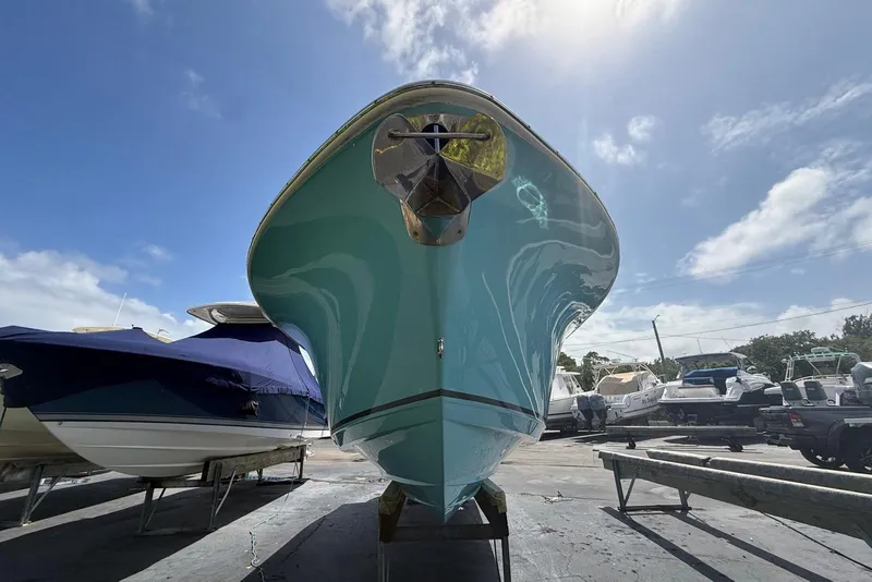 Slide: The Image of 2019 NauticStar 2602 Legacy boat on trailer under clear blue sky. - 4