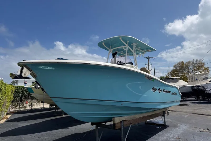 Slide: The Image of 2019 NauticStar 2602 Legacy boat on display under a clear blue sky. - 5