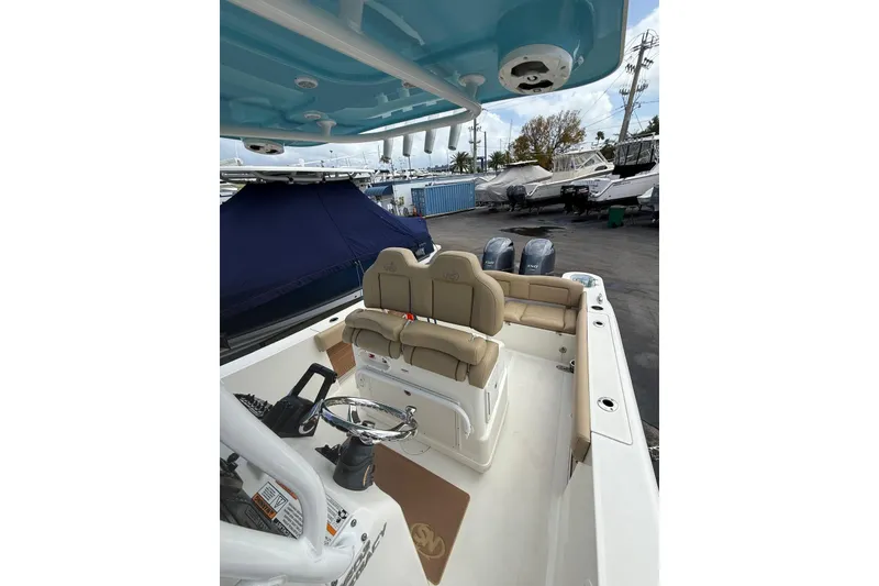 Slide: The Image of 2019 NauticStar 2602 Legacy boat interior with helm and seating area. - 7