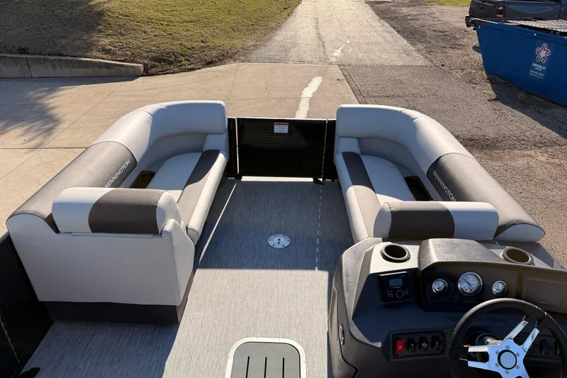 Slide: The Image of 2026 Bennington 22 S-One Quad Bench pontoon boat interior with plush seating and modern dashboard. - 14