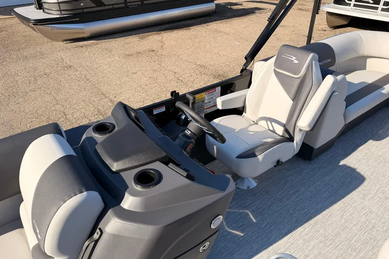 Slide: The Image of 2026 Bennington 22 S-One Quad Bench interior with modern seating and steering console. - 15
