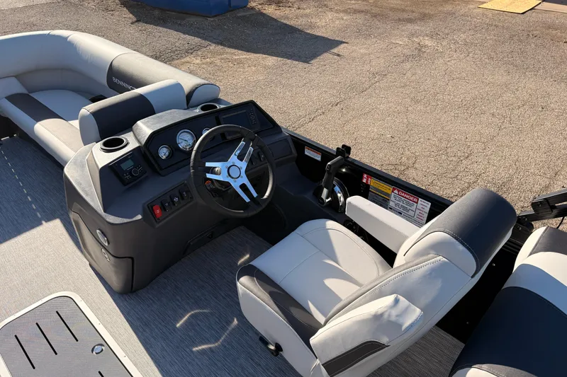 Slide: The Image of 2026 Bennington 22 S-One Quad Bench boat interior with steering wheel and seating. - 19