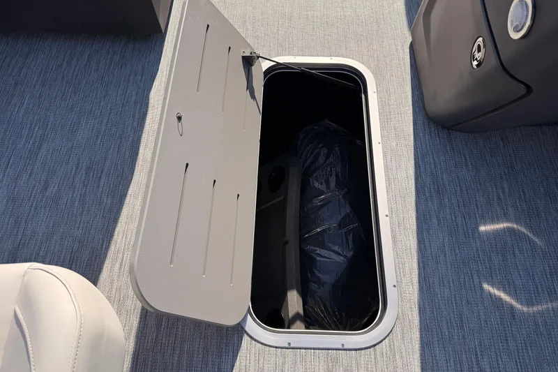 Slide: The Image of Open storage compartment on 2026 Bennington 22 S-One Quad Bench boat. - 23