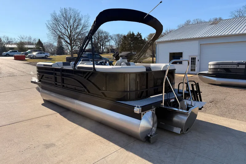 Slide: The Image of 2026 Bennington 22 S-One Quad Bench pontoon boat parked outdoors. - 8
