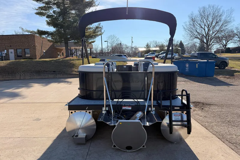 Slide: The Image of 2026 Bennington 22 S-One Quad Bench pontoon boat parked outdoors. - 9