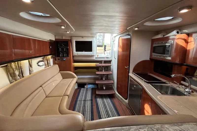 Slide: The Image of Interior of 2015 Crownline 350 SY yacht with kitchen, seating, and stairs. - 11