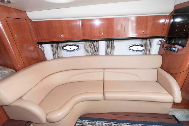 Slide: The Image of Luxurious interior of 2015 Crownline 350 SY yacht with beige leather seating and wooden cabinetry. - 13