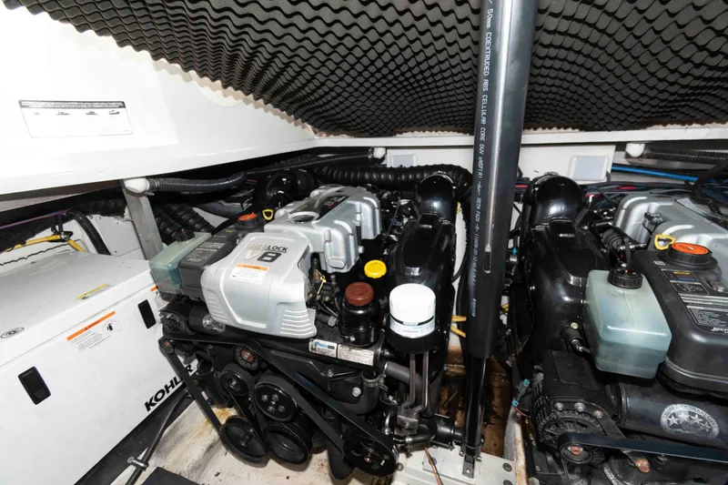 Slide: The Image of Engine room of 2015 Crownline 350 SY boat, featuring dual V8 engines and Kohler generator. - 19