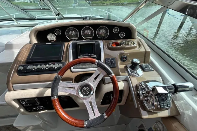 Slide: The Image of Cockpit of 2015 Crownline 350 SY boat with steering wheel and control panel. - 2