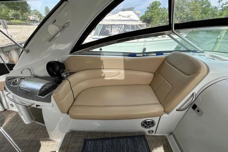 Slide: The Image of 2015 Crownline 350 SY yacht interior with beige seating and kitchenette. - 5