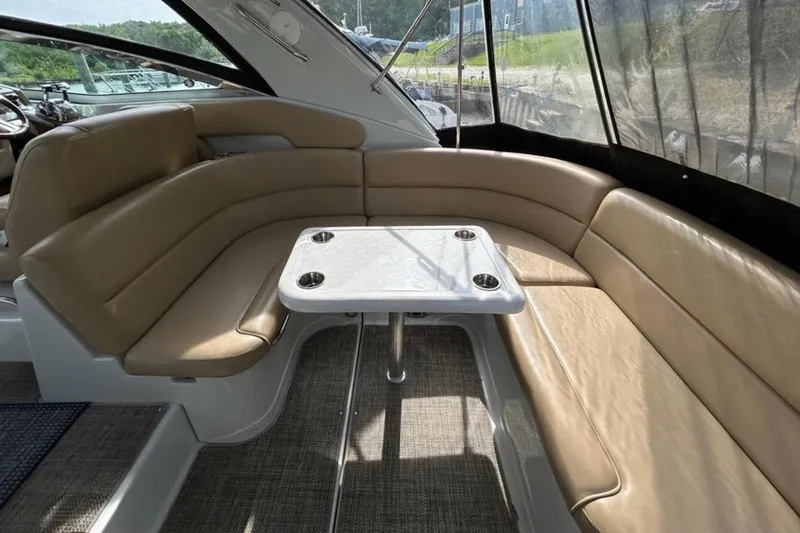 Slide: The Image of Luxurious seating area on 2015 Crownline 350 SY yacht with beige upholstery and table. - 7