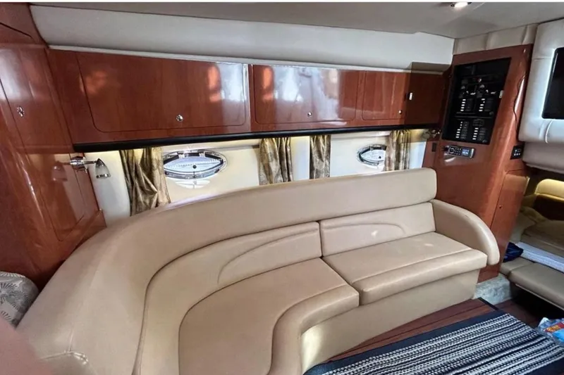 Slide: The Image of Interior of 2015 Crownline 350 SY yacht with beige seating and wooden cabinetry. - 8