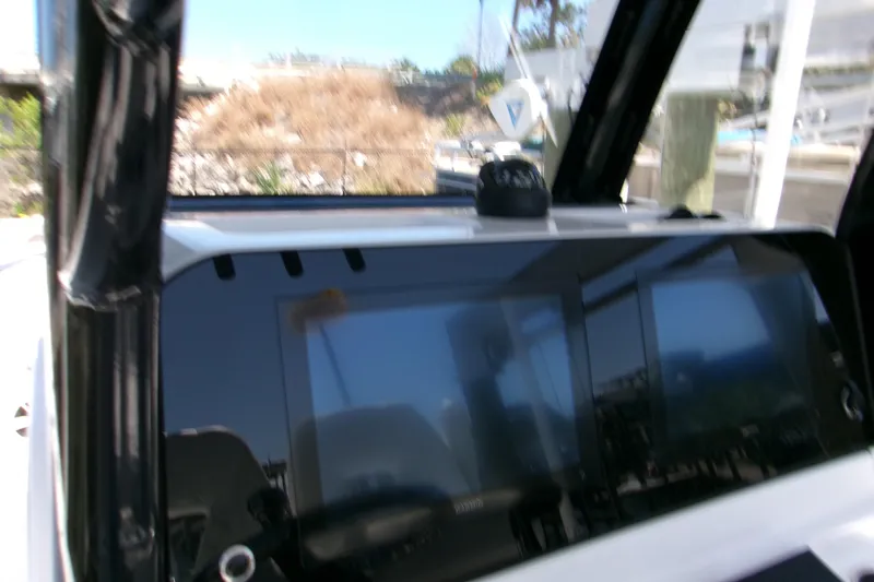 Slide: The Image of 2024 Sportsman Masters 267OE Bay Boat dashboard with modern navigation display. - 10