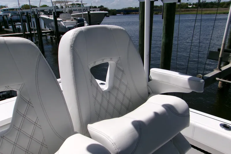 Slide: The Image of Luxurious seating on 2024 Sportsman Masters 267OE Bay Boat, featuring elegant white upholstery. - 13