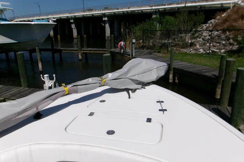 Slide: The Image of 2024 Sportsman Masters 267OE Bay Boat docked near a bridge, covered and secured. - 15