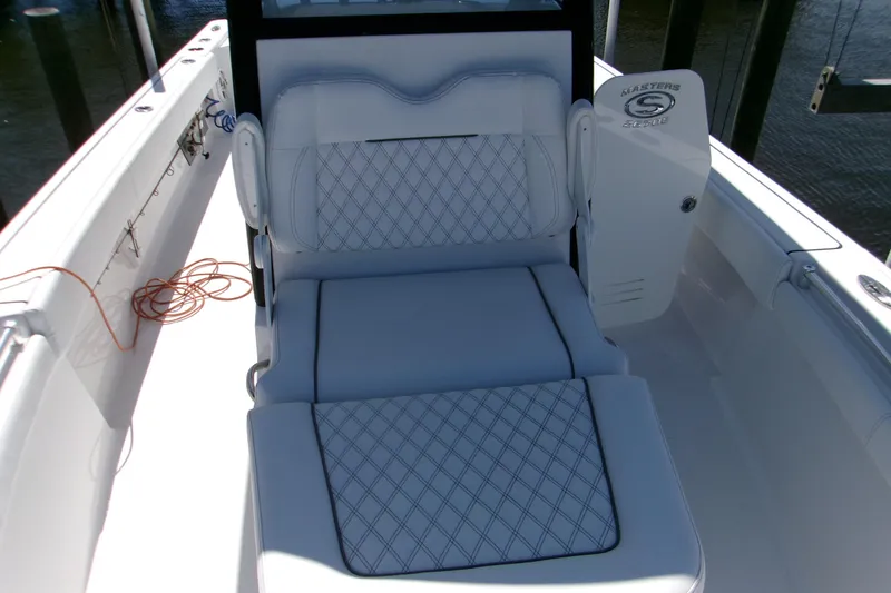 Slide: The Image of 2024 Sportsman Masters 267OE Bay Boat interior with cushioned seating and sleek design. - 16