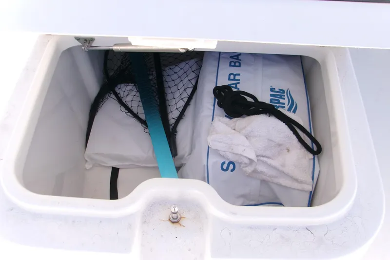 Slide: The Image of Storage compartment in 2024 Sportsman Masters 267OE Bay Boat with fishing gear and accessories. - 18