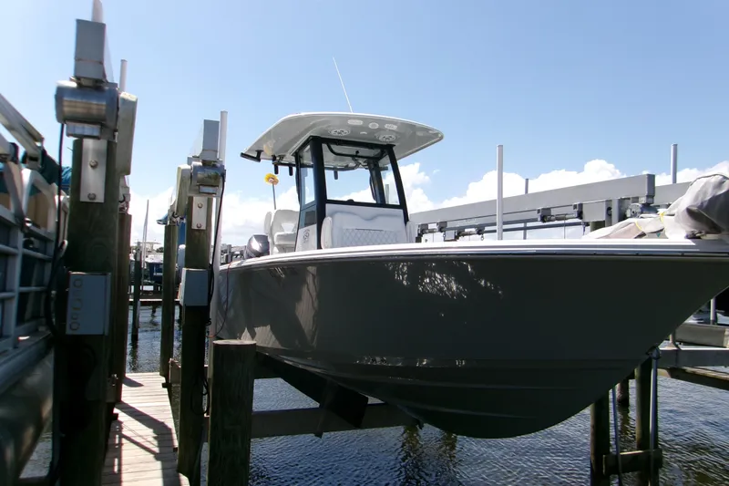 Slide: The Image of 2024 Sportsman Masters 267OE Bay Boat docked at marina under clear sky. - 2