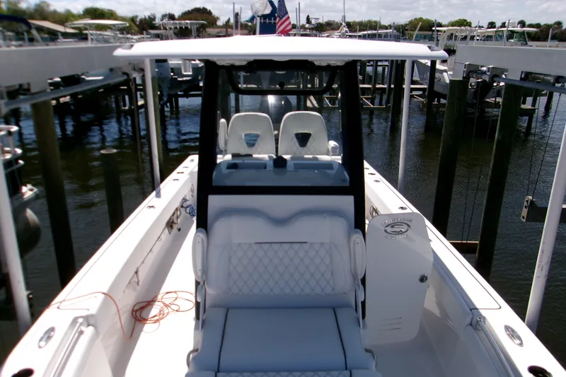 Slide: The Image of 2024 Sportsman Masters 267OE Bay Boat docked, showcasing sleek design and spacious seating. - 21