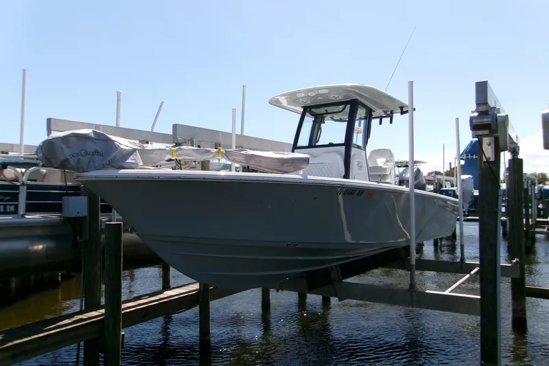 Slide: The Image of 2024 Sportsman Masters 267OE Bay Boat on lift at marina dock. - 22