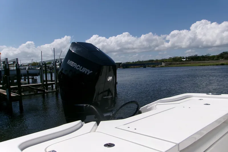 Slide: The Image of 2024 Sportsman Masters 267OE Bay Boat with Mercury engine on calm water. - 3