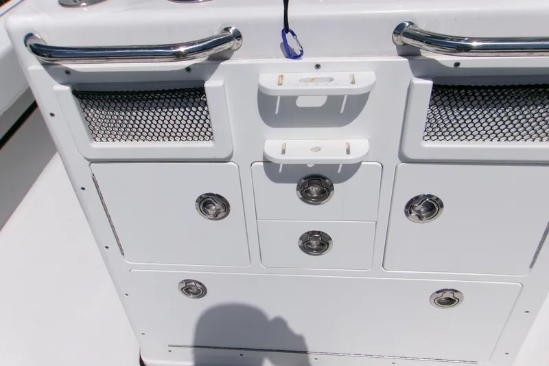 Slide: The Image of 2024 Sportsman Masters 267OE Bay Boat console with storage compartments and stainless steel handles. - 9