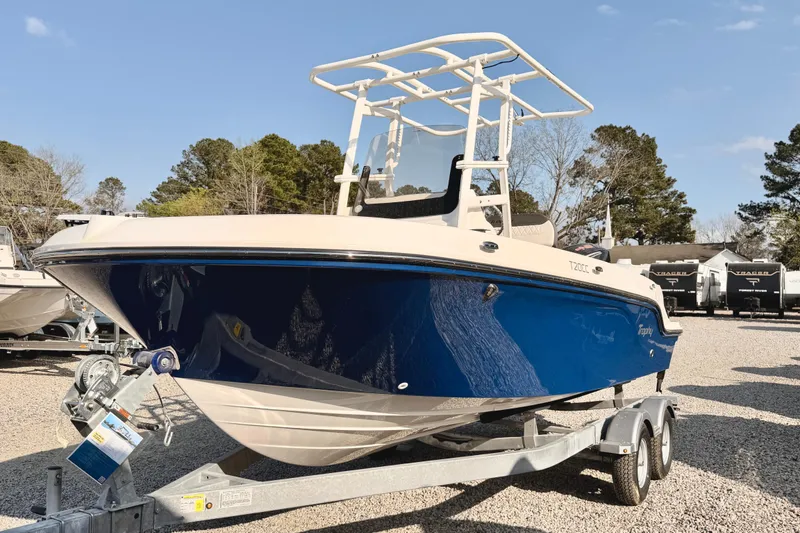 Slide: The Image of 2026 Bayliner Trophy T20CC boat on trailer, blue hull, parked outdoors. - 4