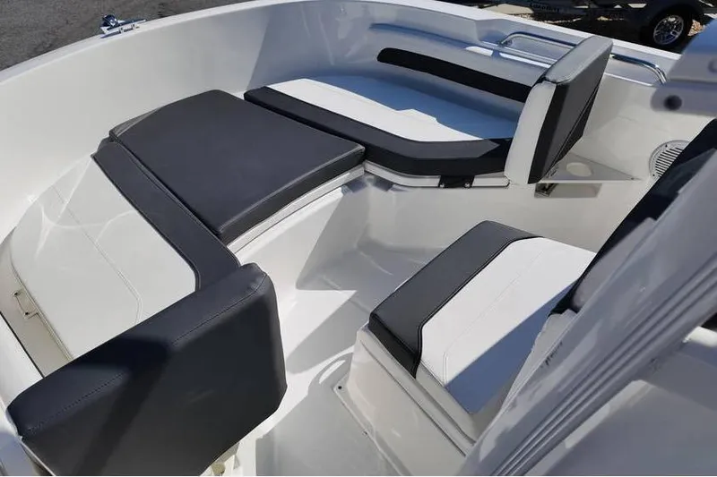 Slide: The Image of Interior seating of 2026 Bayliner Trophy T20CC boat, featuring sleek black and white cushions. - 6