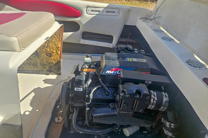 Slide: The Image of 1999 Stingray 220 CS boat engine compartment with visible MerCruiser engine components. - 10