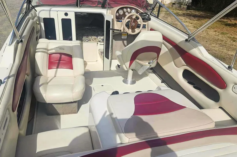 Slide: The Image of Interior of a 1999 Stingray 220 CS boat with red and white seating. - 3