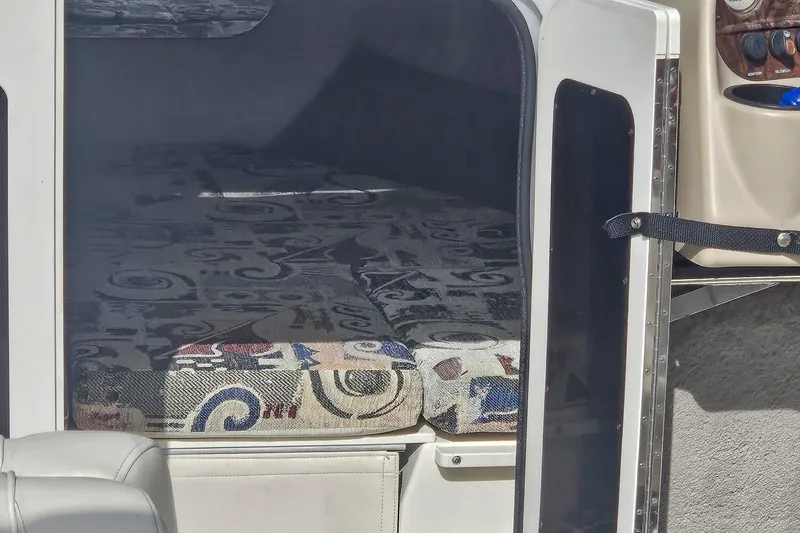 Slide: The Image of Interior cabin of a 1999 Stingray 220 CS boat with patterned cushions. - 8