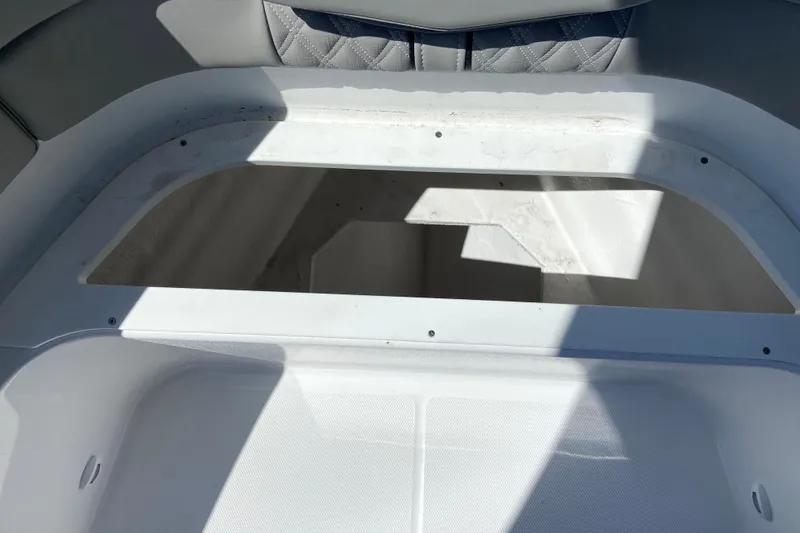 Slide: The Image of Storage compartment of 2026 Monterey Elite 25 OB boat, featuring white interior design. - 24