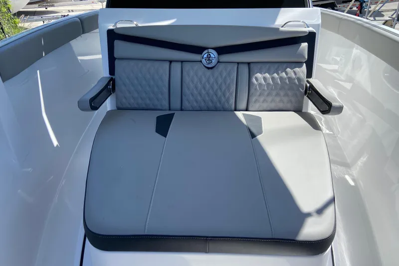 Slide: The Image of 2026 Monterey Elite 25 OB boat interior with cushioned seating and armrests. - 25