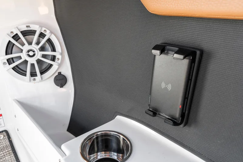 Slide: The Image of 2024 Cobalt CS23 Surf interior with speaker, phone holder, and cup holder. - 12