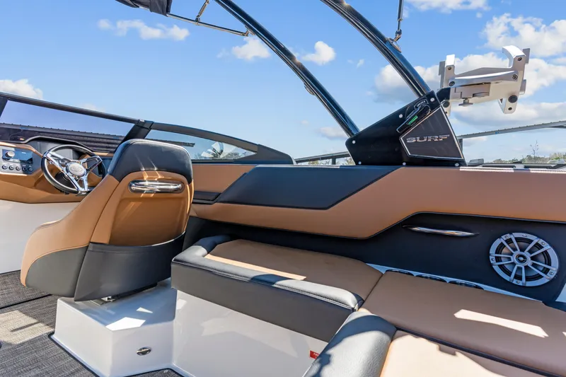 Slide: The Image of 2024 Cobalt CS23 Surf boat interior with luxurious seating and modern dashboard design. - 22
