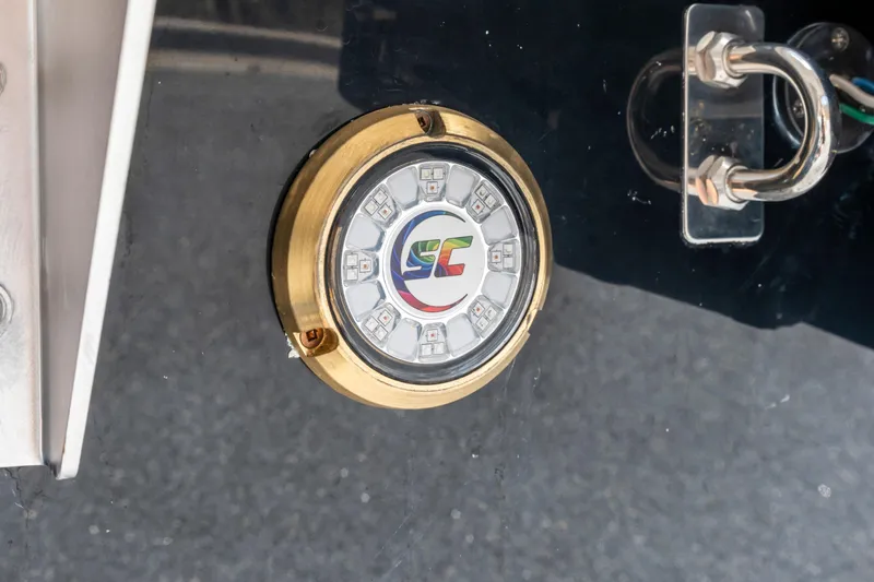 Slide: The Image of 2024 Cobalt CS23 Surf boat detail with LED light and metal fixture. - 25