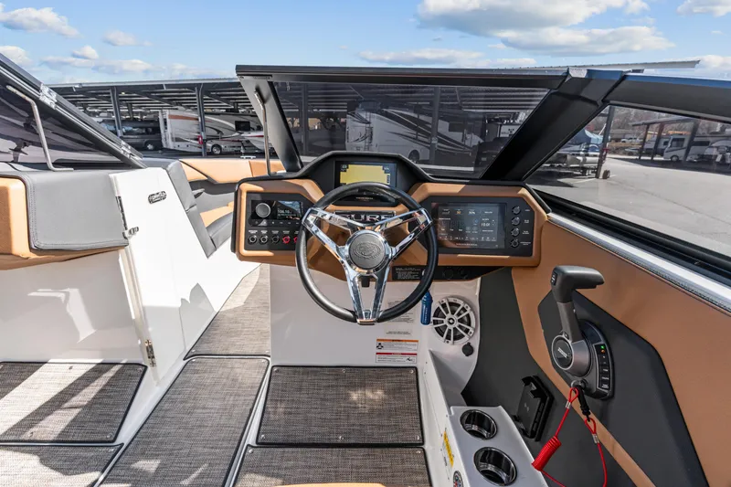 Slide: The Image of 2024 Cobalt CS23 Surf boat dashboard with modern controls and steering wheel. - 7