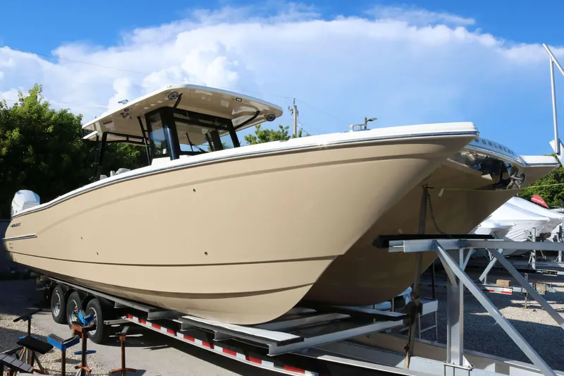 The Image of 2023 World Cat 400 CC-X boat on trailer under blue sky. - 1