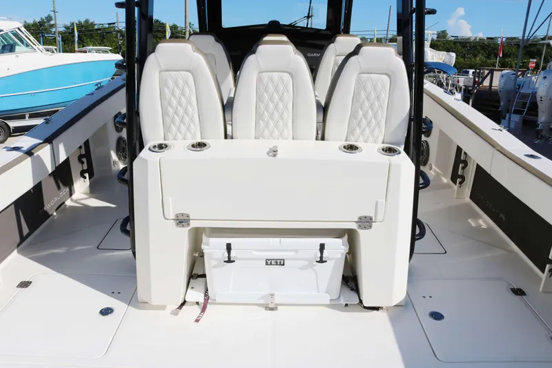 Slide: The Image of 2023 World Cat 400 CC-X boat interior with luxury seating and Yeti cooler. - 10