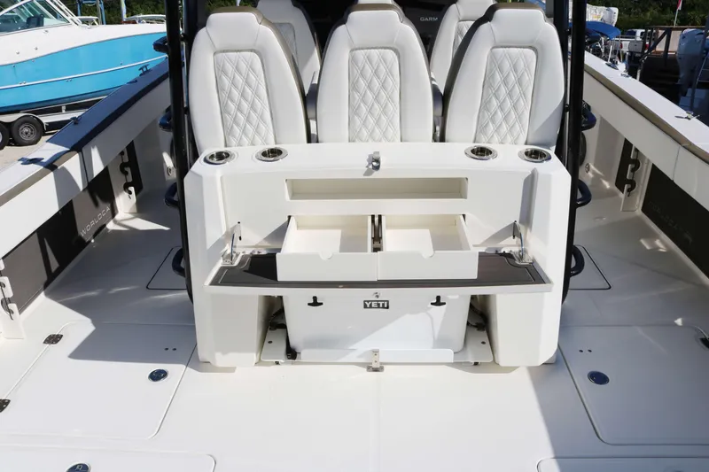 Slide: The Image of 2023 World Cat 400 CC-X boat interior with luxury seating and Yeti cooler. - 12