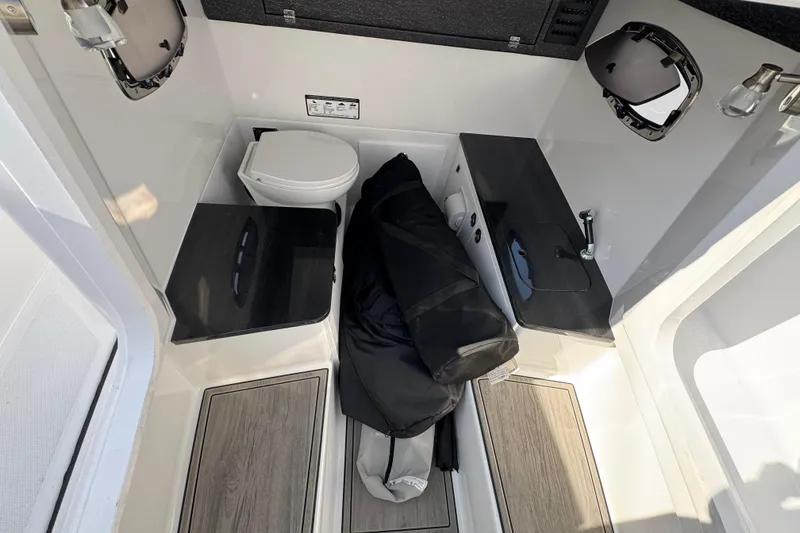 Slide: The Image of Interior of 2026 Monterey Elite 25 OB boat with toilet and sink. - 11