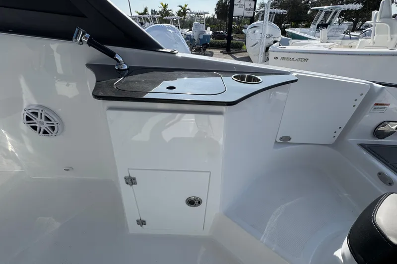 Slide: The Image of 2026 Monterey Elite 25 OB boat interior with sink and storage area. - 12